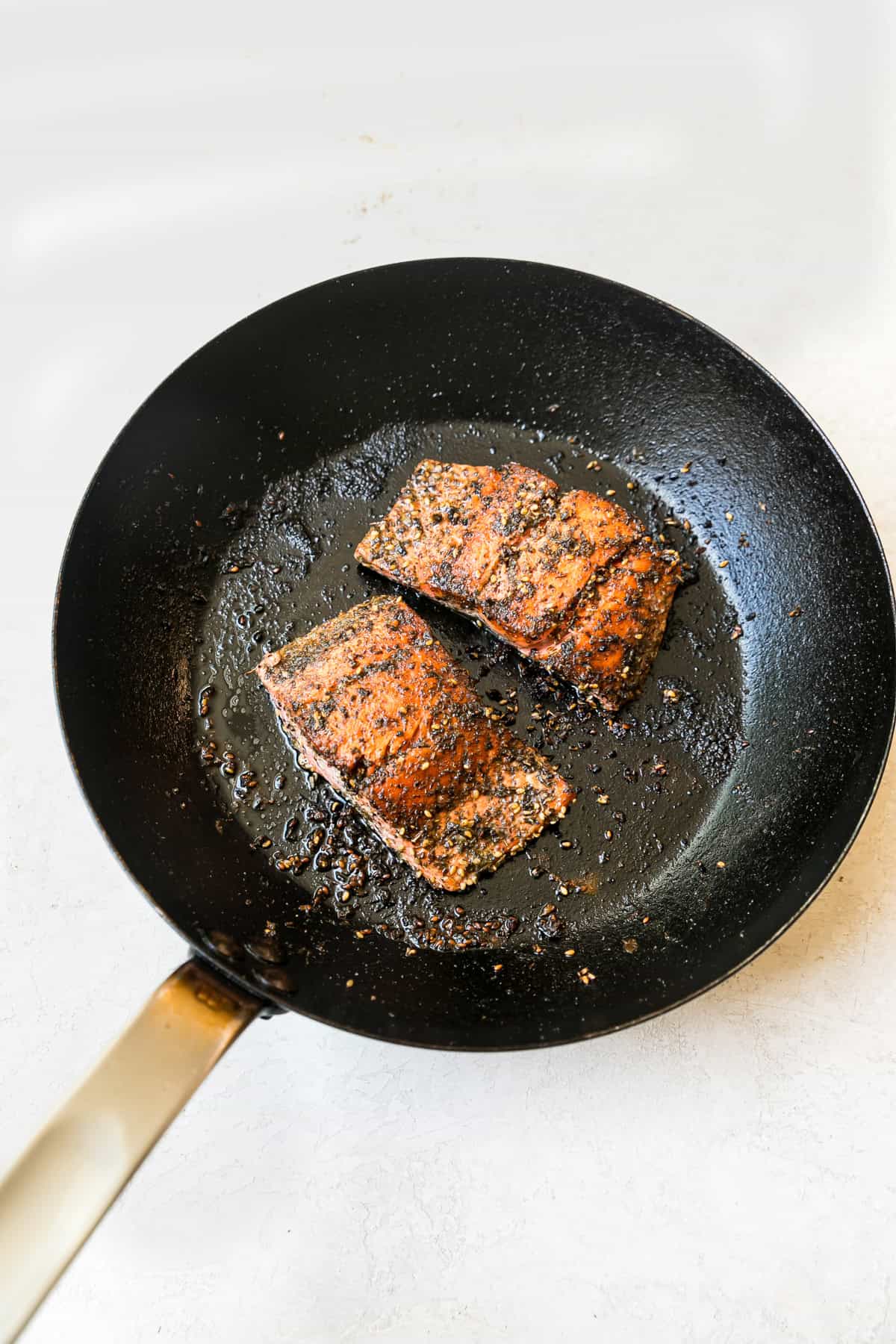 greek salmon seasoned and cooked in cast iron