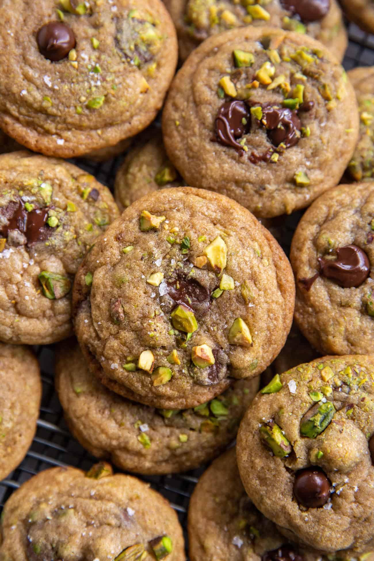 overhead view of pistachio chocolate chip cookies with flaked sea salt.