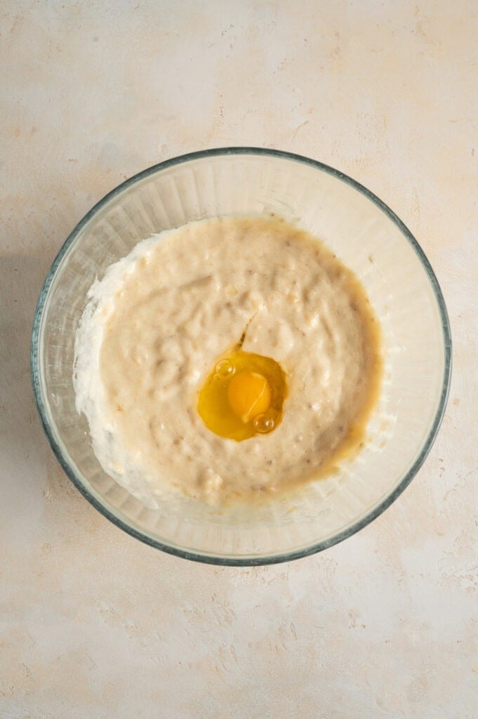 egg in banana batter in glass bowl.