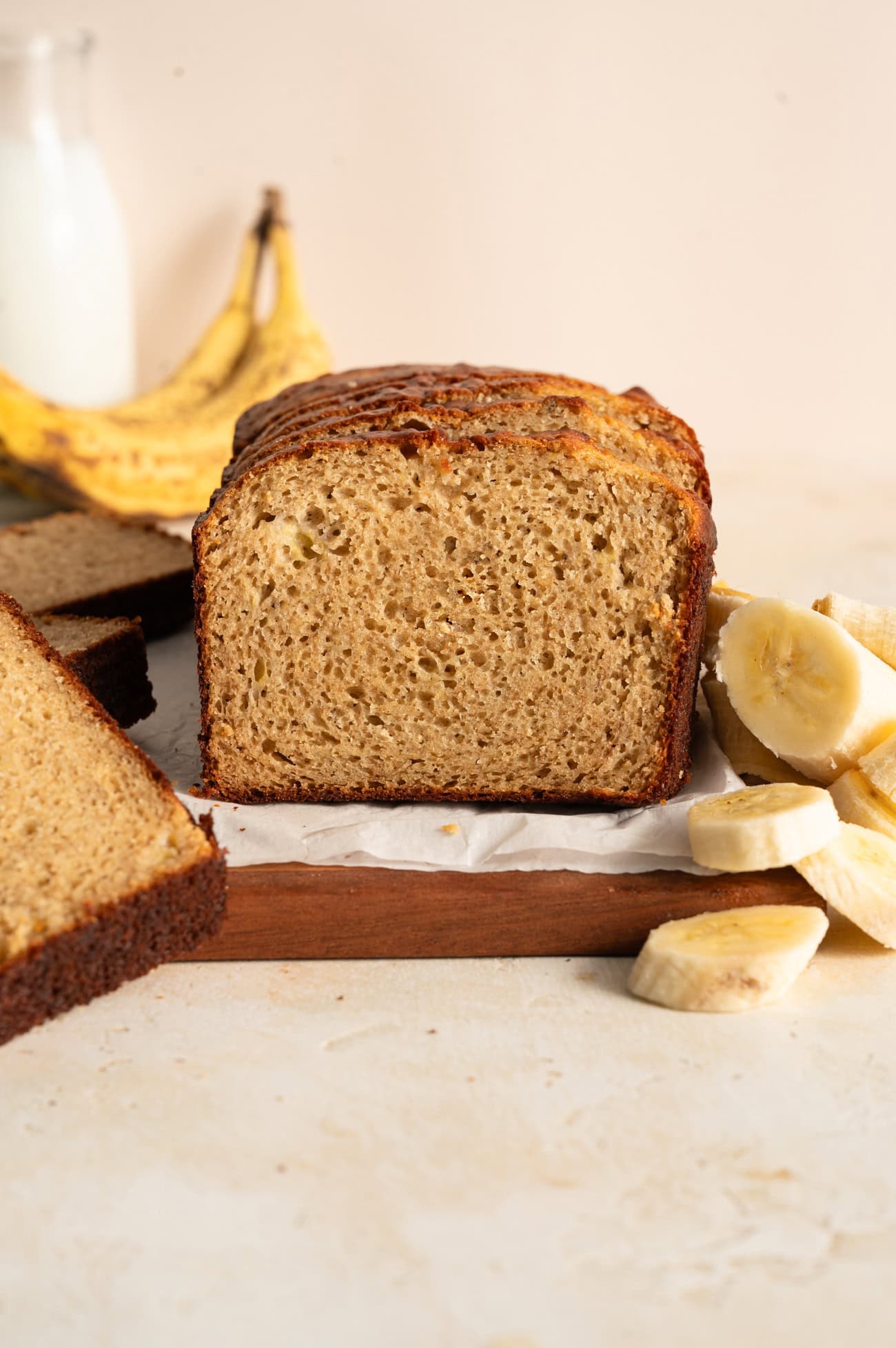straight on view of protein banana bread next to fresh banana slices.