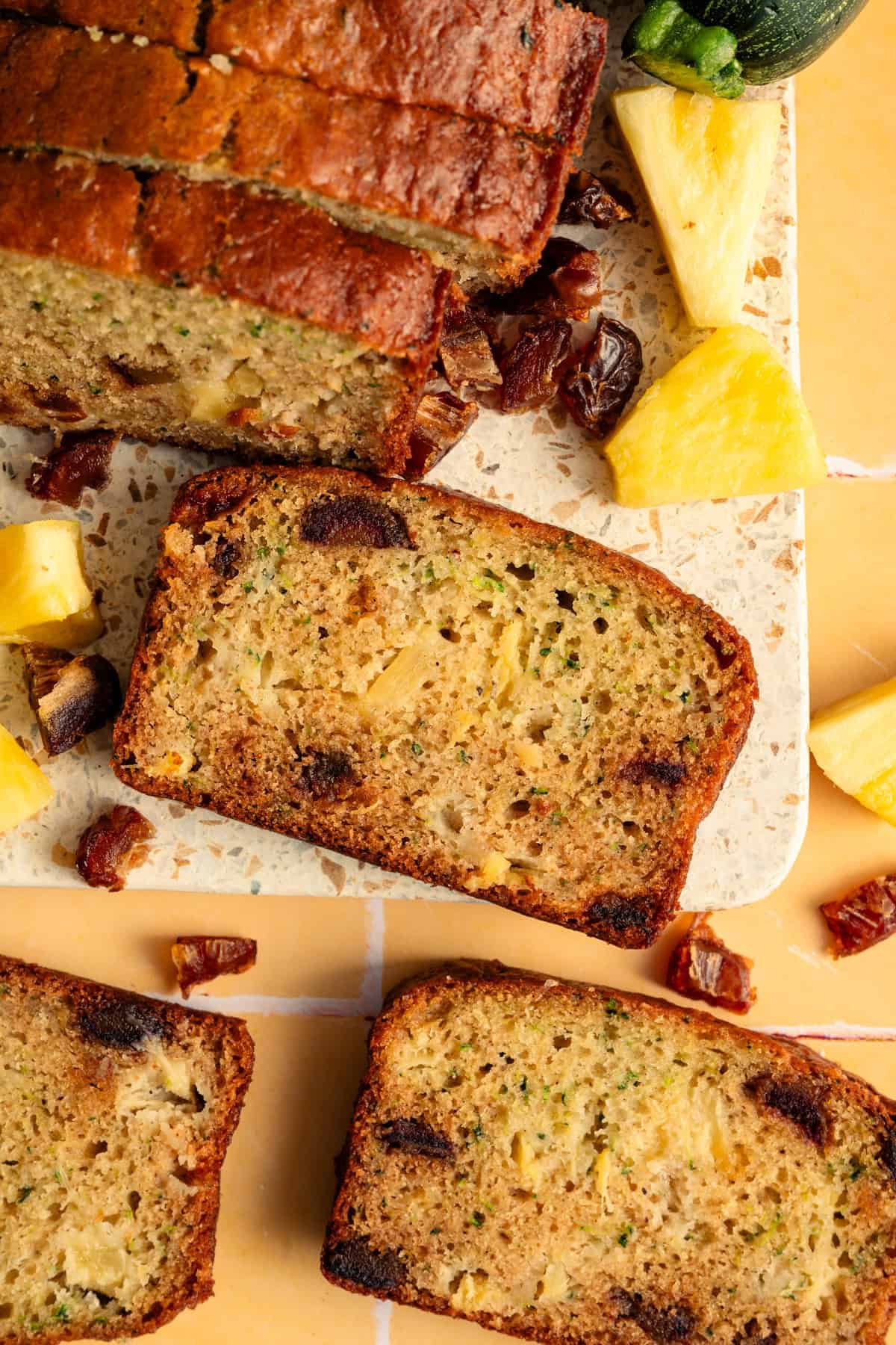 overhead view of zucchini bread with pineapple and dates.