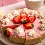 no bake strawberry cheesecake with fresh strawberries and piped whipped cream.