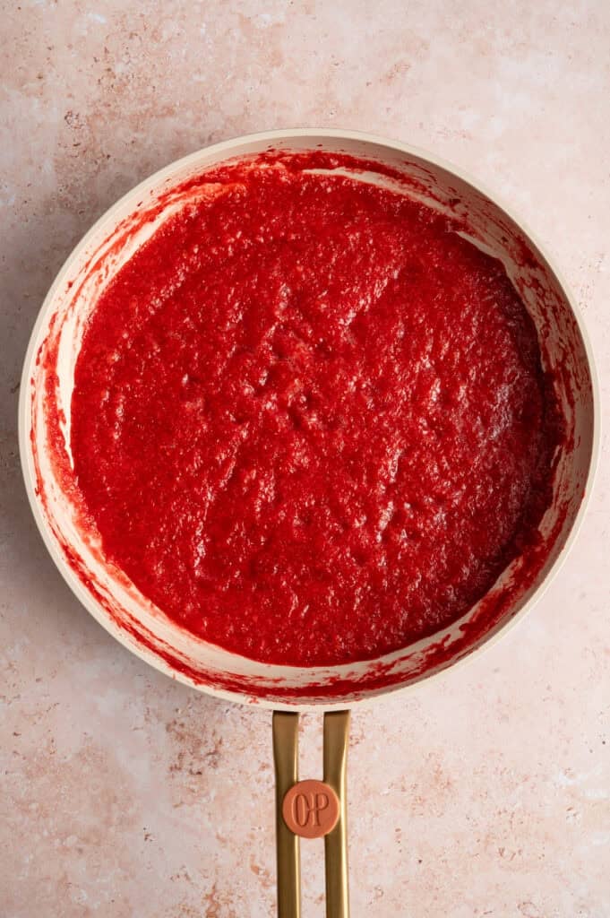 cooked down blended strawberries in pan.