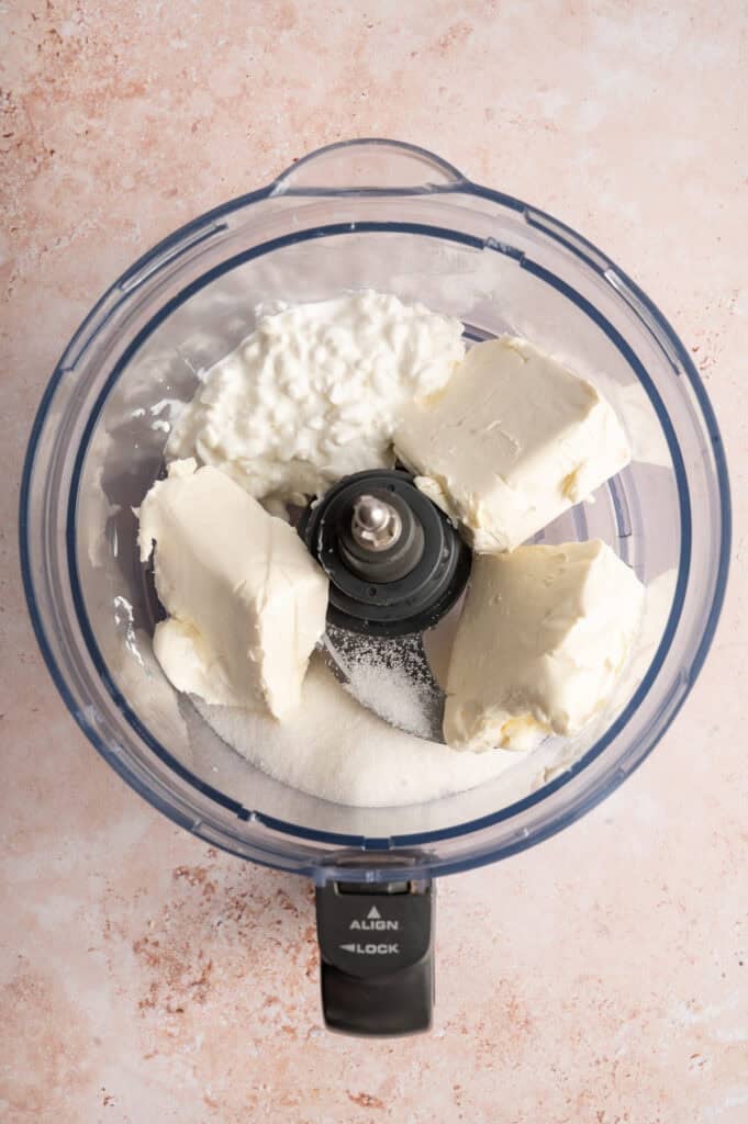 cream cheese, sugar and cottage cheese in food processor bowl.