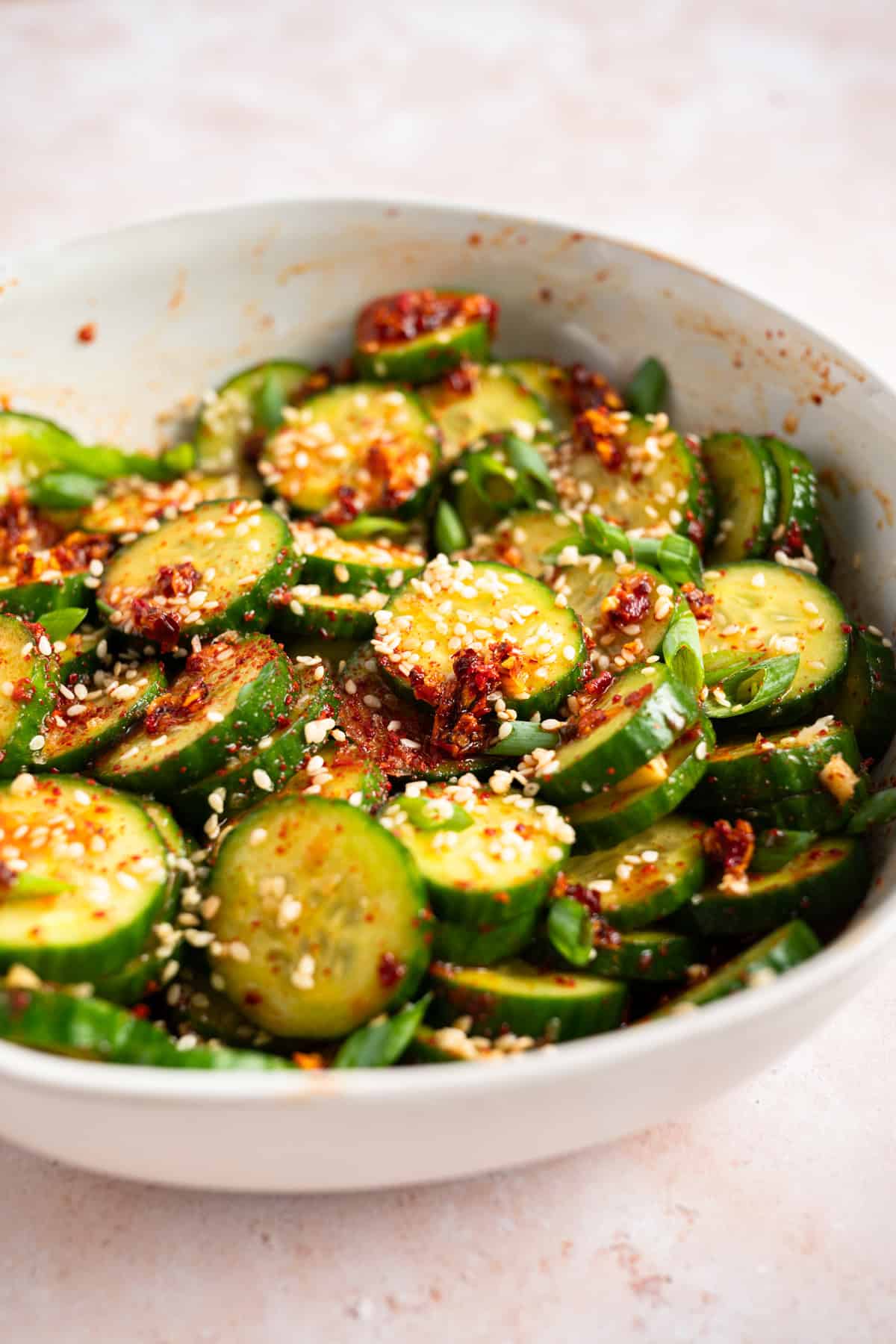 asian cucumber salad recipe in white bowl.