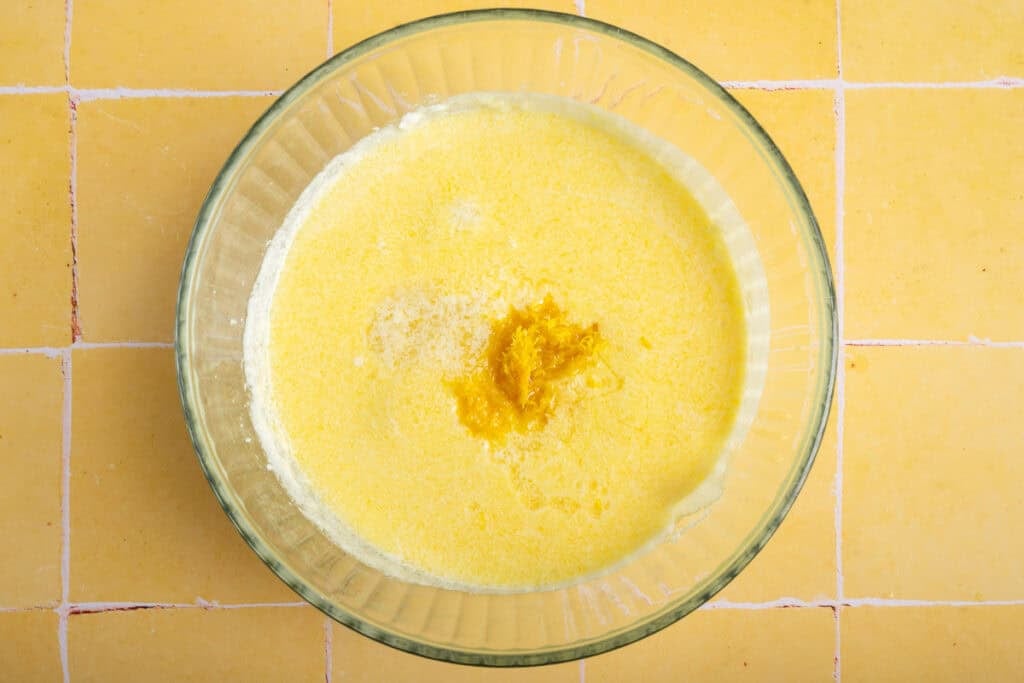 wet ingredients in glass bowl with lemon zest.