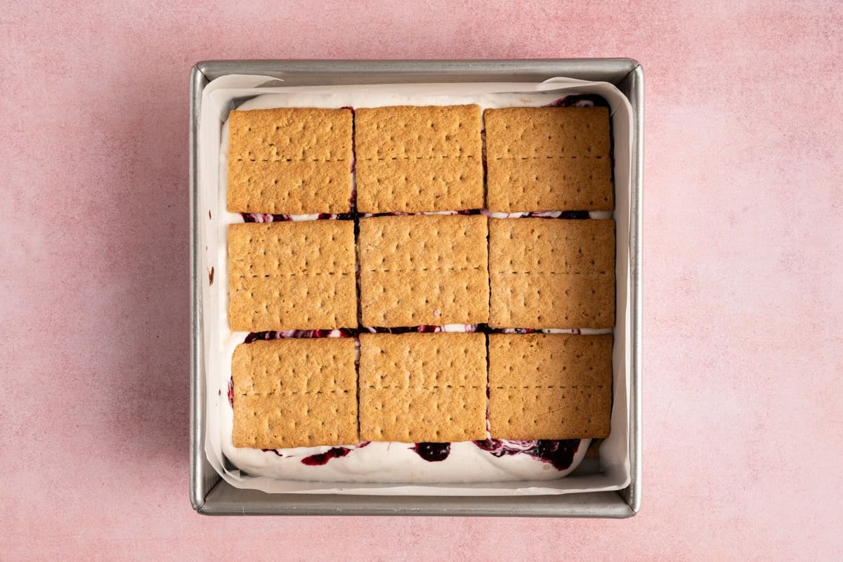 graham crackers lined up in square metal pan.