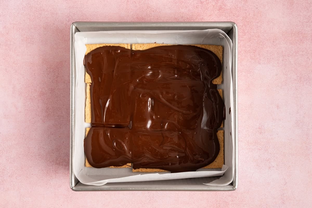 melted chocolate over top of graham cracker squares.