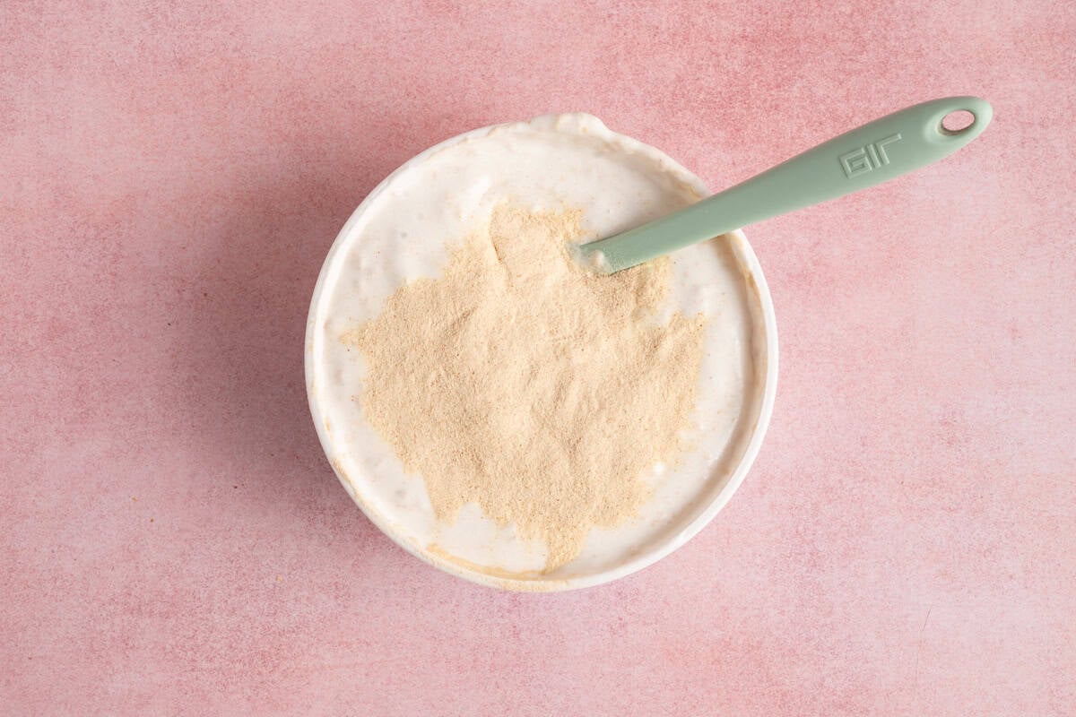protein powder in container of whipped topping.